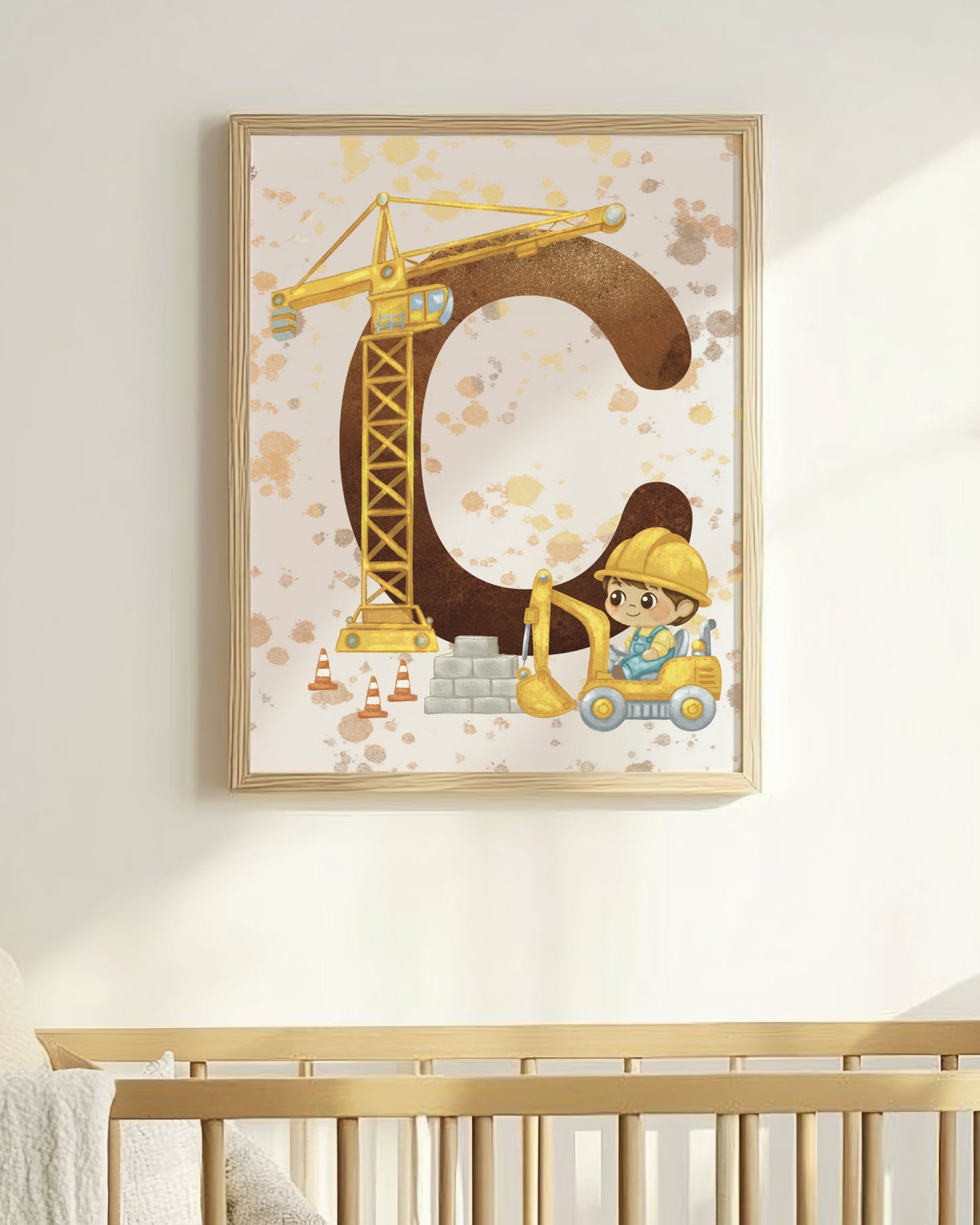 Nursery room with a crib and framed artwork of a letter 'C' with a construction theme.