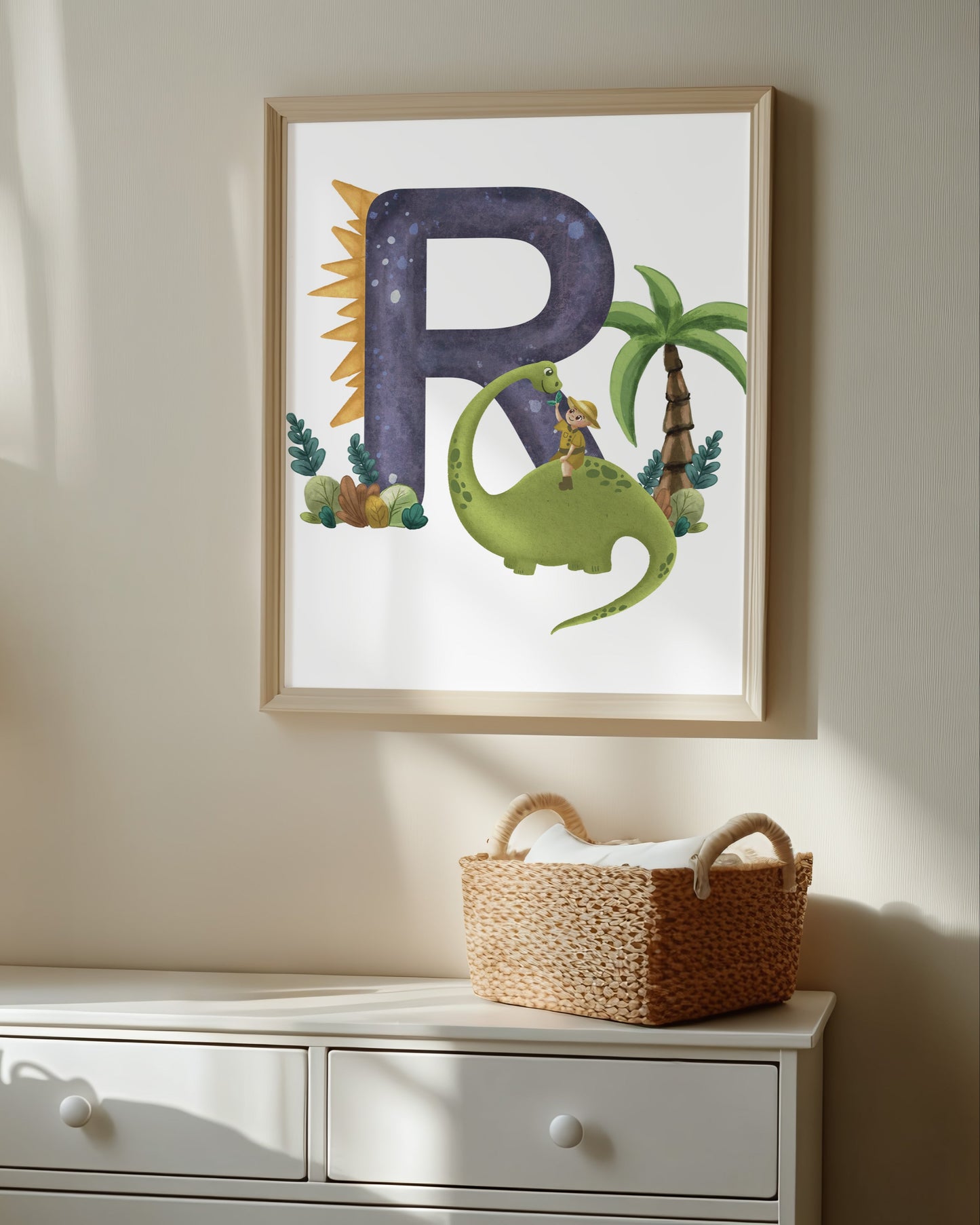 Nursery room with a framed alphabet poster, teddy bear, and lamp.