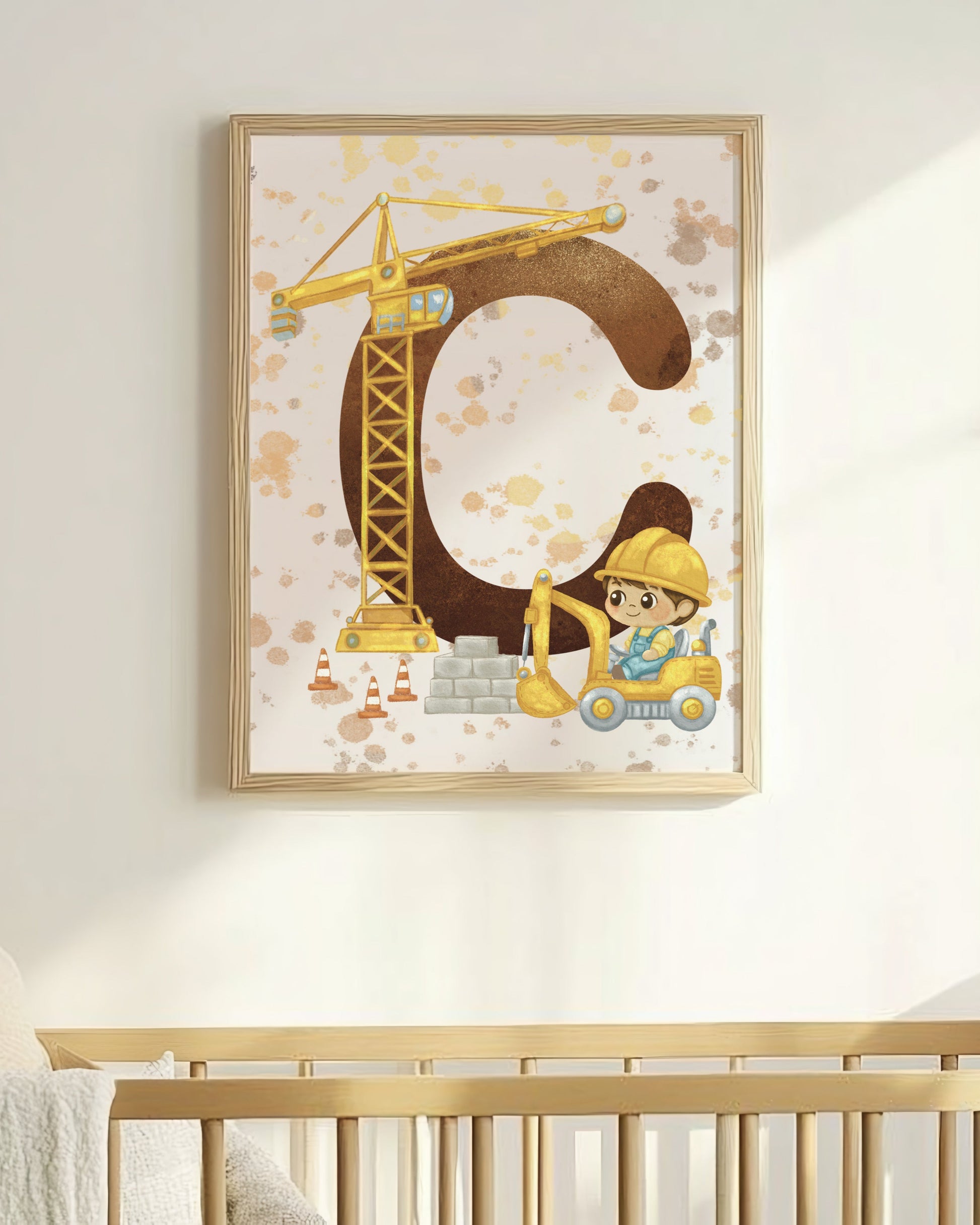 Nursery room with a crib and framed artwork of a letter 'C' with a construction theme.
