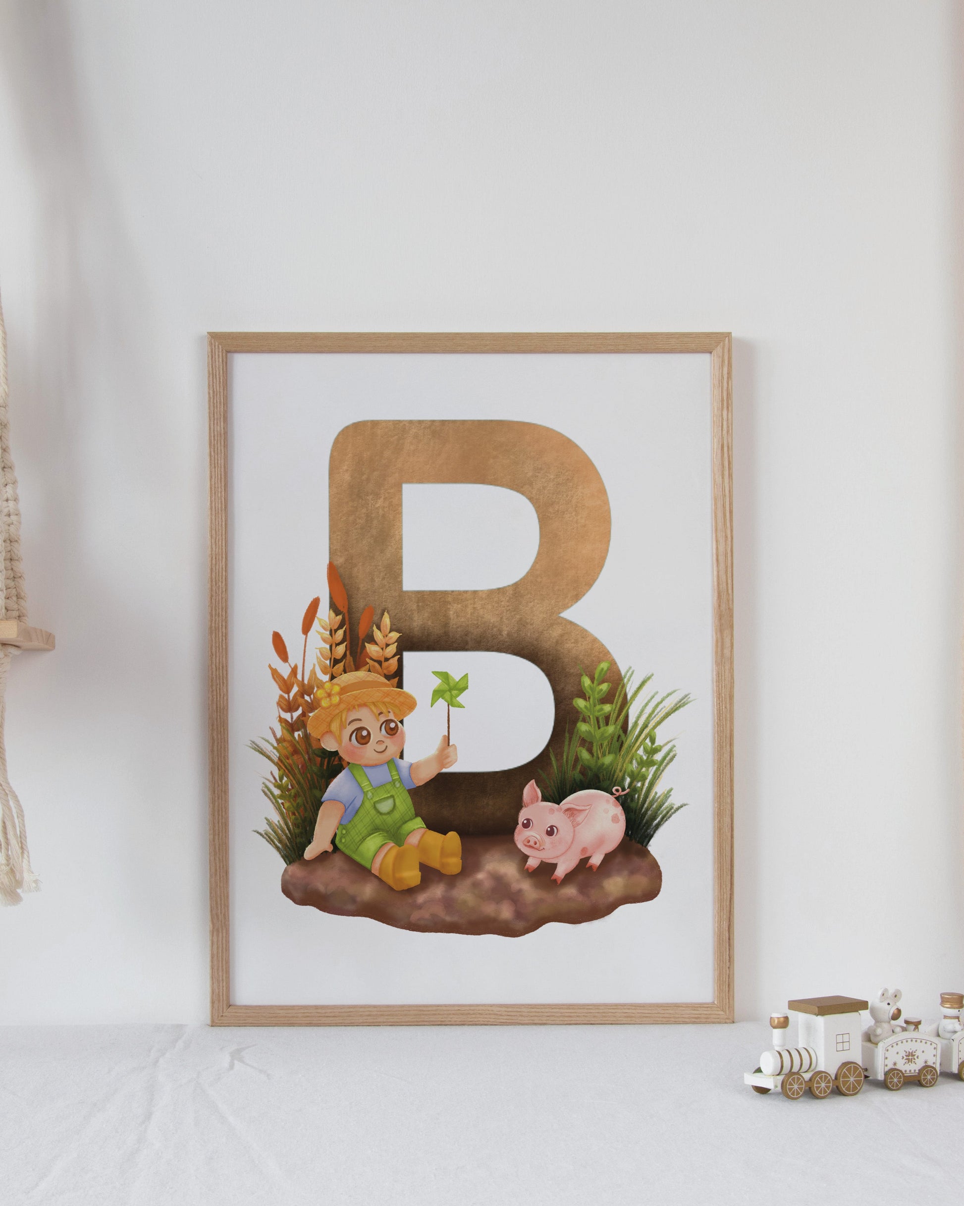 Framed artwork with letter 'B' and cartoon character on a white wall with decorative elements.